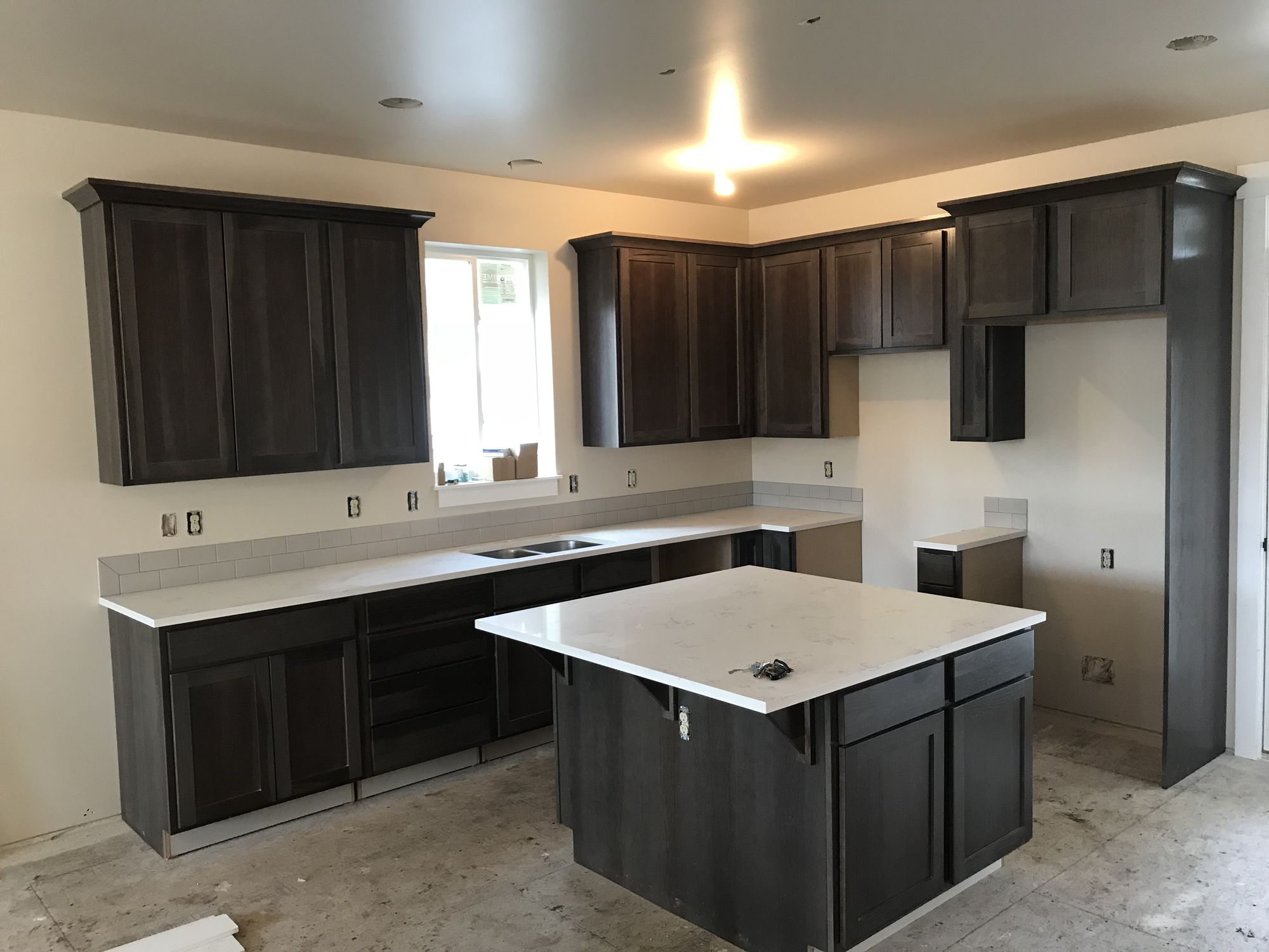 Kitchen with a dark island, Ona Lane