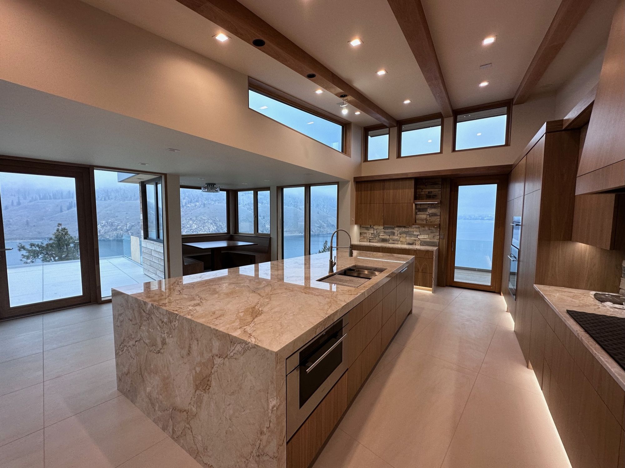 Kitchen with a stone waterfall island and lake views, Roosevelt